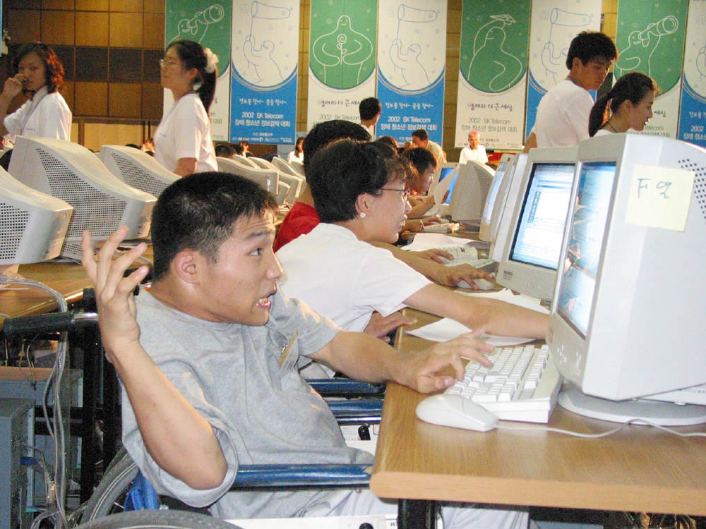 Photo shows 2002 SK Telecom Internet Search Contest for Physically Challenged Youth in which 304 students (152 teams) from 94 special schools for disabled people.